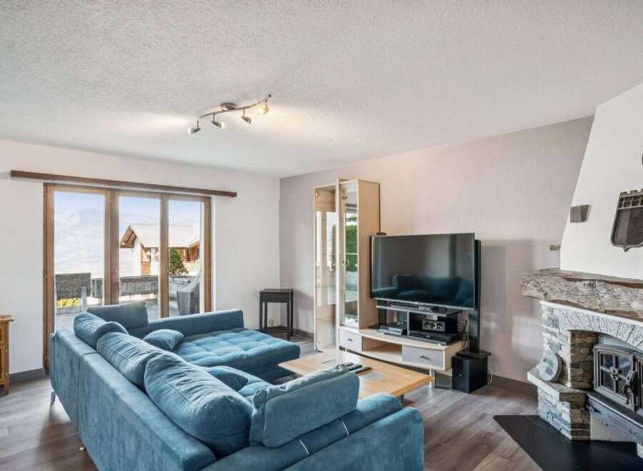 This stunning property boasts a spacious living room with a cozy fireplace, perfect for relaxing evenings.