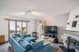 This stunning property boasts a spacious living room with a cozy fireplace, perfect for relaxing evenings.