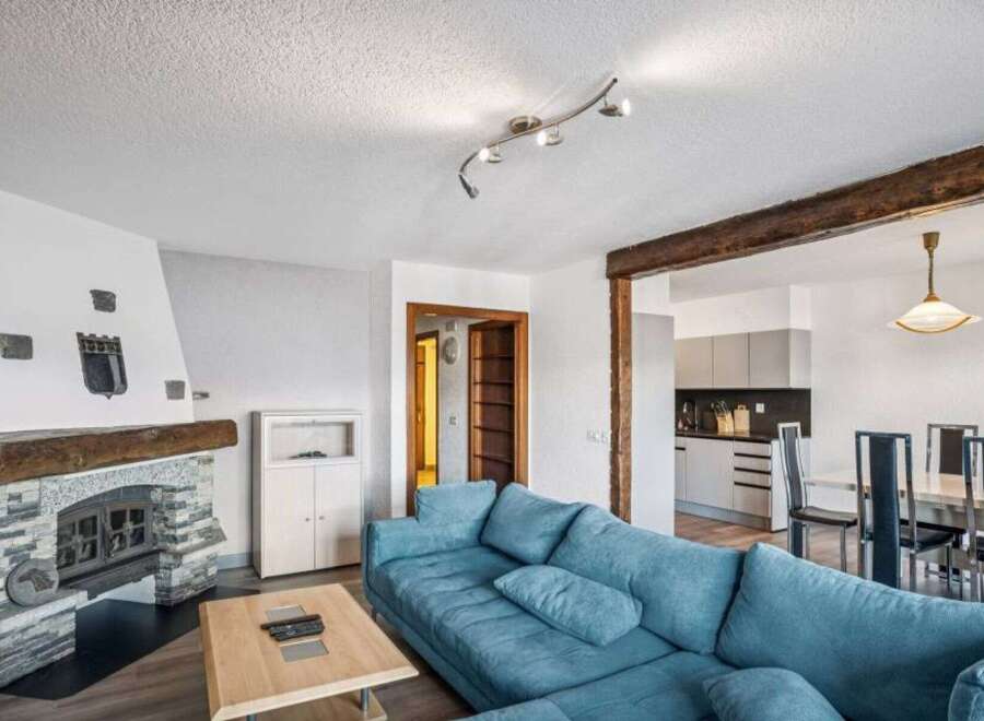 This stunning property boasts a cozy living room with a beautiful fireplace, perfect for relaxing evenings.
