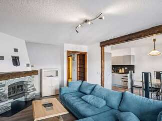 This stunning property boasts a cozy living room with a beautiful fireplace, perfect for relaxing evenings.