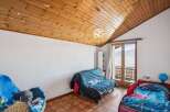 Discover this charming bedroom featuring a unique wooden ceiling adorned with star-shaped accents.