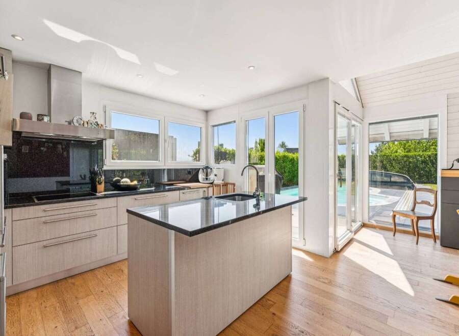 This stunning kitchen boasts a modern design with sleek cabinetry and a spacious island.