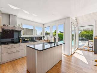 This stunning kitchen boasts a modern design with sleek cabinetry and a spacious island.