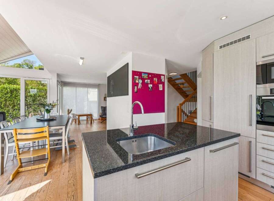 This stunning property boasts a modern kitchen with sleek granite countertops and stainless steel appliances, perfect for culinary enthusiasts.
