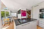 This stunning property boasts a modern kitchen with sleek granite countertops and stainless steel appliances, perfect for culinary enthusiasts.