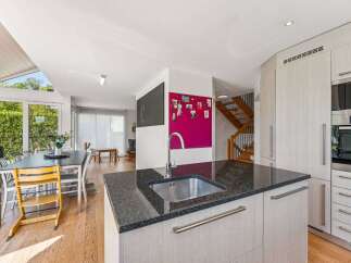 This stunning property boasts a modern kitchen with sleek granite countertops and stainless steel appliances, perfect for culinary enthusiasts.