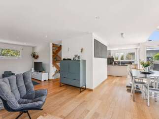 This stunning property boasts a modern open-plan living space with beautiful hardwood floors.