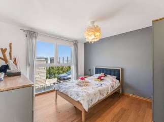 This charming bedroom offers a cozy retreat with its inviting ambiance and stylish design.