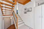 This stunning property boasts a modern staircase with wooden accents, creating a warm and inviting atmosphere.