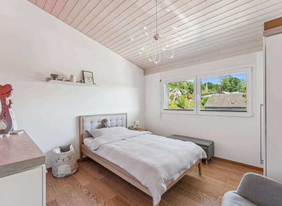This charming bedroom features a cozy bed, perfect for a relaxing retreat.