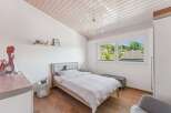 This charming bedroom features a cozy bed, perfect for a relaxing retreat.
