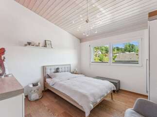 This charming bedroom features a cozy bed, perfect for a relaxing retreat.