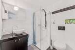 This modern bathroom features a sleek design with clean lines and bright white tiles.