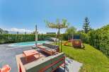Enjoy luxurious outdoor living in this stunning property! Featuring a private pool, a cozy seating area, and a charming play area for kids, this home is perfect for relaxation and entertainment.