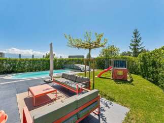 Enjoy luxurious outdoor living in this stunning property! Featuring a private pool, a cozy seating area, and a charming play area for kids, this home is perfect for relaxation and entertainment.