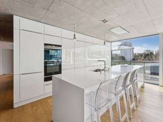 Experience modern luxury in this stunning kitchen! Featuring sleek white cabinetry, a spacious island, and high-end appliances, this space is perfect for both cooking and entertaining.