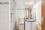 This charming bathroom features a modern design with a sleek vanity and a stylish shower enclosure.