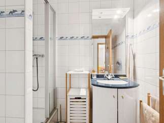 This charming bathroom features a modern design with a sleek vanity and a stylish shower enclosure.
