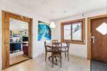 This charming property features a cozy dining area with a round wooden table and chairs, perfect for intimate gatherings.