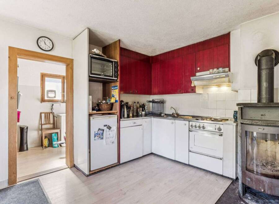 This charming kitchen features a unique blend of vintage and functional design.