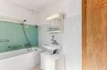 Discover this charming bathroom featuring a classic bathtub and a convenient showerhead.