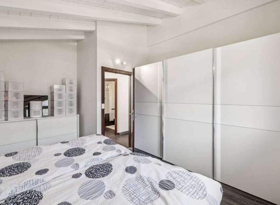 This bright and airy bedroom features a modern design with ample storage space.