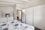 This bright and airy bedroom features a modern design with ample storage space.