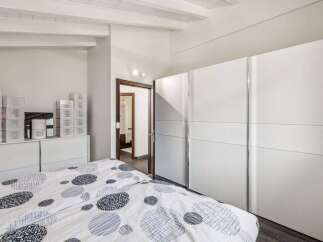 This bright and airy bedroom features a modern design with ample storage space.