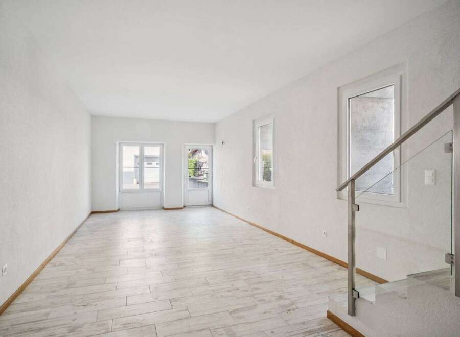 Discover the elegance of this bright and airy living space, featuring pristine white walls and a modern aesthetic.