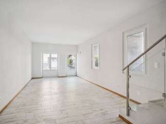 Discover the elegance of this bright and airy living space, featuring pristine white walls and a modern aesthetic.