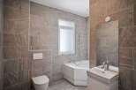This modern bathroom features stylish tile work and a sleek design.