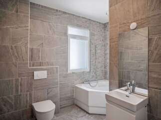 This modern bathroom features stylish tile work and a sleek design.