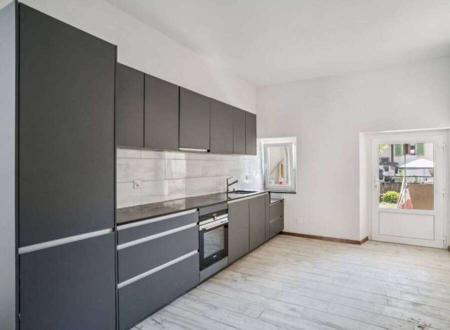 Modern kitchen with sleek gray cabinetry and a minimalist design.