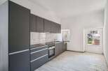 Modern kitchen with sleek gray cabinetry and a minimalist design.