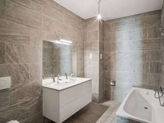 This modern bathroom features stylish tile work and a sleek, minimalist design.