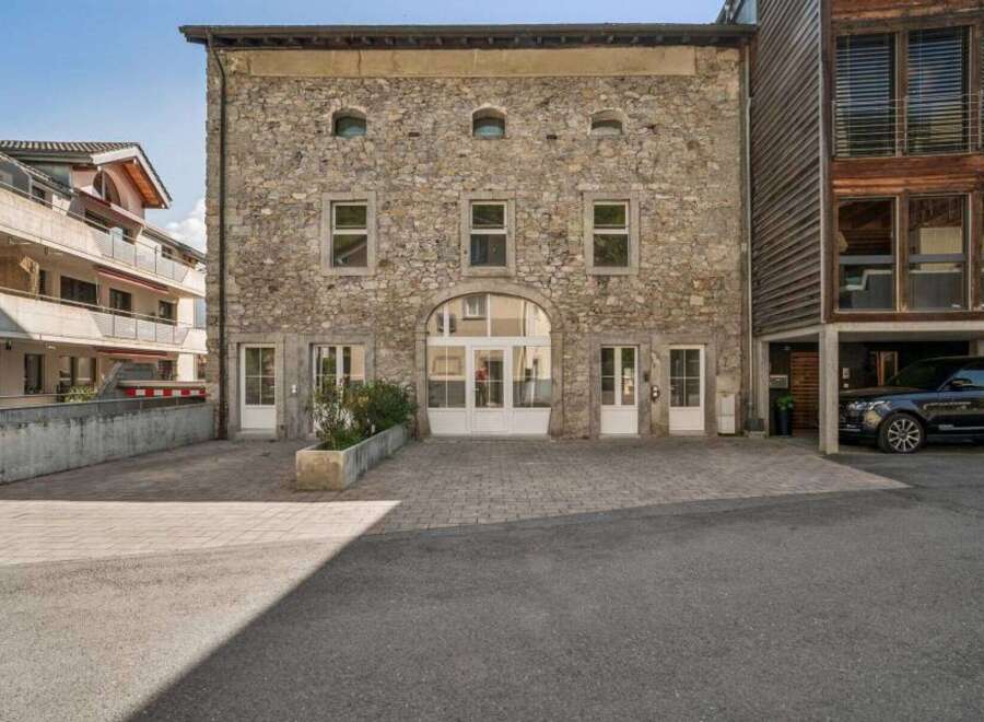 Discover this stunning property featuring a unique stone facade and charming architectural details.