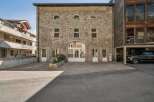 Discover this stunning property featuring a unique stone facade and charming architectural details.