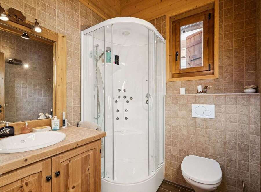This charming bathroom boasts a rustic aesthetic, perfect for a cozy retreat.