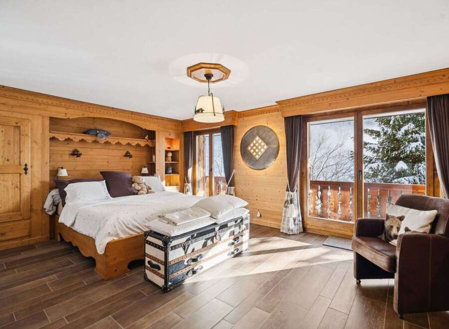 Experience the charm of this stunning bedroom, featuring exquisite wooden paneling and a cozy ambiance.