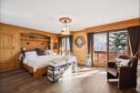 Experience the charm of this stunning bedroom, featuring exquisite wooden paneling and a cozy ambiance.