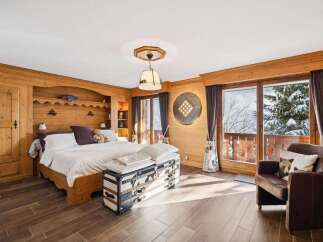Experience the charm of this stunning bedroom, featuring exquisite wooden paneling and a cozy ambiance.