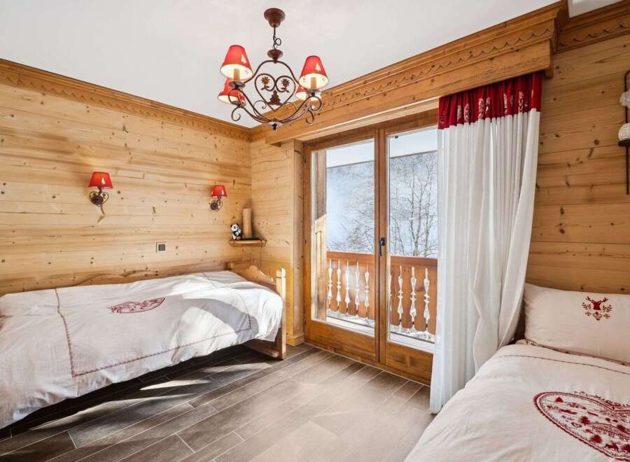 This charming bedroom features a cozy wooden interior, creating a warm and inviting atmosphere.