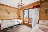 This charming bedroom features a cozy wooden interior, creating a warm and inviting atmosphere.