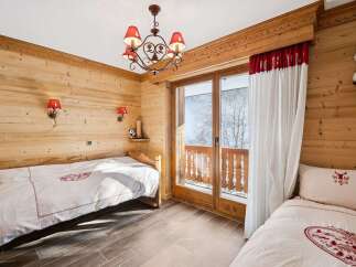 This charming bedroom features a cozy wooden interior, creating a warm and inviting atmosphere.