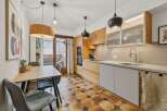 This stunning kitchen boasts a modern design with sleek cabinetry and a beautiful tile floor.