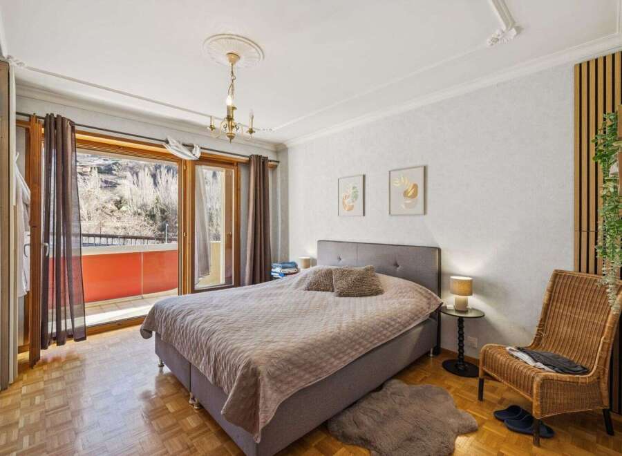 This inviting bedroom boasts a cozy atmosphere with a comfortable bed and stylish decor.