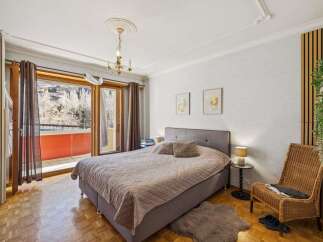 This inviting bedroom boasts a cozy atmosphere with a comfortable bed and stylish decor.