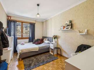 Discover this cozy bedroom featuring a comfortable bed, perfect for relaxation.