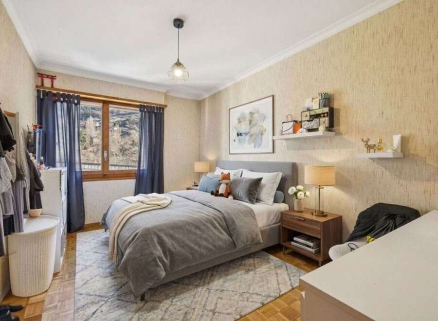 This cozy bedroom features a comfortable bed with soft bedding and a stylish rug.
