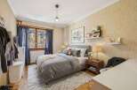 This cozy bedroom features a comfortable bed with soft bedding and a stylish rug.